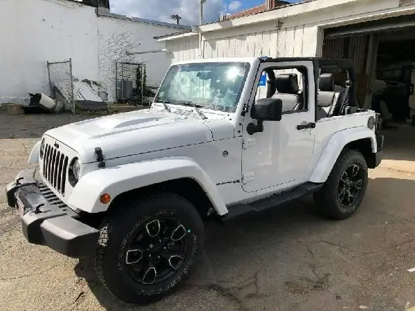 The finished white Jeep parked outside Guaranty Auto in Clinton